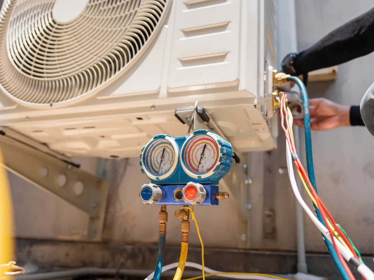 Refrigerant gauges connected to an outdoor air-conditioning unit